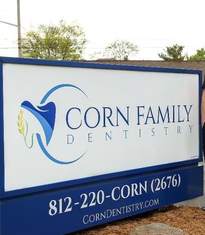 The Corn Family Dentistry sign outside our Edinburgh office, with the number 812-220-CORN