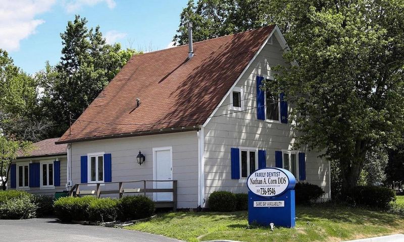 Our Franklin office: a white cottage with blue shutters on West Jefferson Street